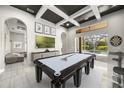 Spacious game room with a pool table, stylish decor, and access to the outdoor pool area at 743 Mills Estate Pl, Chuluota, FL 32766