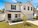 Charming two-story home with a well-manicured lawn, welcoming front porch, and a convenient two-car garage at 815 Savona Pl, Kissimmee, FL 34758