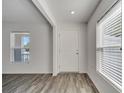 Bright entryway featuring wood-look flooring, recessed lighting and a large front door at 815 Savona Pl, Kissimmee, FL 34758