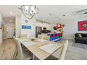 Open-concept dining area flowing to the modern kitchen with stainless steel appliances at 8959 Stinger Dr, Champions Gate, FL 33896