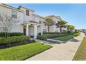 Townhouse exterior boasting well-maintained landscaping and a covered entryway at 8959 Stinger Dr, Champions Gate, FL 33896