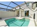 Relaxing backyard with a sparkling pool and screened-in lanai creates a perfect outdoor retreat at 8959 Stinger Dr, Champions Gate, FL 33896