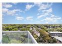 Scenic exterior view from balcony overlooking trees and blue skies at 101 S Eola Dr # 910, Orlando, FL 32801