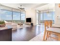 Bright living room featuring floor-to-ceiling windows, wood floors, and modern furnishings at 101 S Eola Dr # 910, Orlando, FL 32801