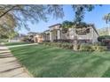 Beautifully landscaped home featuring a manicured lawn and mature trees on a corner lot at 10112 Shortwood Ln, Orlando, FL 32836