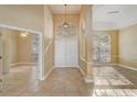 Spacious foyer with arched doorway, tile flooring, and large windows at 10112 Shortwood Ln, Orlando, FL 32836