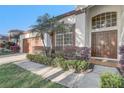 Charming front entrance with lush landscaping and double doors at 10112 Shortwood Ln, Orlando, FL 32836