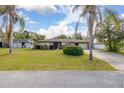 Charming single story home featuring a well-maintained lawn with mature landscaping at 1061 Radford Dr, Deltona, FL 32738