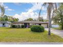 Charming single story home featuring a well-maintained lawn with mature landscaping at 1061 Radford Dr, Deltona, FL 32738