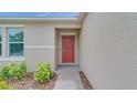 Close-up of the front door and entryway with manicured landscaping at 144 Jones Fish Camp Rd, Edgewater, FL 32141