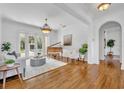 Bright living room with hardwood floors, a piano, French doors to a pool, and neutral-toned furniture at 1630 Lasbury Ave, Winter Park, FL 32789