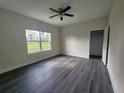 New bedroom with natural light, ceiling fan, closet, and luxury vinyl plank flooring at 1647 Redfin Dr, Kissimmee, FL 34759