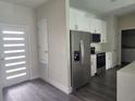 New kitchen with modern appliances, stainless steel refrigerator, and white cabinets at 1647 Redfin Dr, Kissimmee, FL 34759