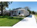 Exterior view showing the driveway, fresh lawn, and easy to maintain landscaping at 1806 Dixie Belle Dr, Orlando, FL 32812