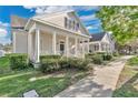 Inviting home exterior with a covered porch, manicured bushes, and a walkway to the front door at 202 Longview Ave, Kissimmee, FL 34747