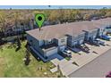 Aerial view of a well-maintained townhome community, showcasing ample parking and lush green spaces, with a water tower visible at 2037 Canny Cv, Winter Park, FL 32792