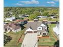 Beautiful two-story home with a three car garage, well-manicured lawn, and waterfront access at 2072 Starboard Dr, Geneva, FL 32732