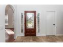 Foyer with a decorative front door, tile flooring, and white walls, creating a bright and welcoming entry at 2217 Wekiva Reserve Blvd, Apopka, FL 32703