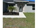 Front entrance of home with attractive landscaping and manicured lawn at 258 Fraser Rd, Debary, FL 32713