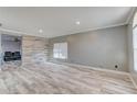 Bright living room with wood-look flooring, light gray walls, and decorative wood accent wall at 321 Cape Sable Dr, Orlando, FL 32825