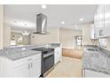 Bright kitchen with modern appliances, granite countertops, and stylish white cabinets at 321 Ferdinand Dr, Longwood, FL 32750