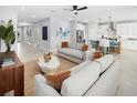 Bright living room featuring neutral tones, contemporary decor, and an open layout connecting to the kitchen at 3526 Douglas Fir Dr, Apopka, FL 32703