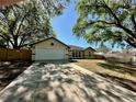 Lovely single-story home with spacious driveway and well-kept landscaping at 3548 Picciola Cutoff Rd, Fruitland Park, FL 34731