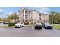 Exterior view of condo building showing balconies and dedicated parking for residents and visitors at 3605 Conroy Rd # 537, Orlando, FL 32839