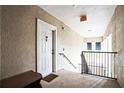 Well-lit hallway featuring an exit sign and a view of stairs, enhancing safety and accessibility at 3605 Conroy Rd # 537, Orlando, FL 32839