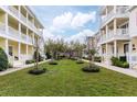 Townhome complex with a manicured green space and symmetrical landscaping at 378 Blue Bayou Ln, Winter Springs, FL 32708