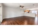 Spacious living room with hardwood floors, ceiling fan, and view of the kitchen at 378 Blue Bayou Ln, Winter Springs, FL 32708