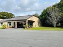 Inviting single-story home featuring an attached carport and well-maintained landscaping at 482 Windmeadows St # 482, Altamonte Springs, FL 32701