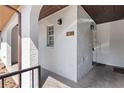 Close up of the front entrance showing unit number, stucco wall, and covered porch leading to the main door at 4825 Lighthouse Cir # 4825, Orlando, FL 32808