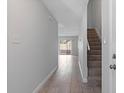 Hallway view with light-colored floors leading to glass doors and a staircase on the right at 4825 Lighthouse Cir # 4825, Orlando, FL 32808