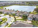 An aerial view shows a home with a lake view in a serene community at 5647 Barletta Dr, St Cloud, FL 34771