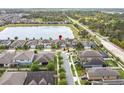 An aerial view shows a home with a lake view in a serene community at 5647 Barletta Dr, St Cloud, FL 34771