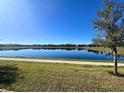 Pond view featuring a walkway and residential homes in the background at 5647 Barletta Dr, St Cloud, FL 34771