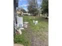 Wide backyard with a combination of grass and bare ground, some clutter at 5915 Colchester Dr, Orlando, FL 32812