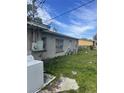 View of house with an exterior, a washer, and a duck in the unkept yard at 5915 Colchester Dr, Orlando, FL 32812