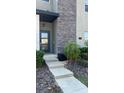 Close up of front door showing stone facade and concrete stairs at 992 Leader St, Davenport, FL 33896