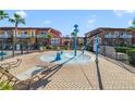 Community splash pad area with playful water features and nearby lounge chairs at 1001 Park Ridge Cir, Kissimmee, FL 34746