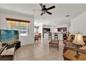 Open concept living room with tile flooring, seamlessly flowing into the kitchen and dining area at 10081 Cobalt Bay Rd, Orlando, FL 32827