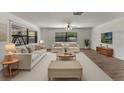 Bright and airy living room with large windows, modern furniture, and a neutral color palette at 1021 Mare Bello Dr, Winter Park, FL 32792