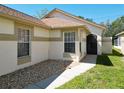 Inviting home exterior featuring a stone accent garden, and well-maintained landscaping, providing a warm, welcoming feel at 11624 Peach Grove Ln, Orlando, FL 32821