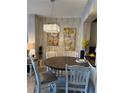 Dining area with a modern chandelier, wood table, and stylish decor at 1247 Travertine Ter, Sanford, FL 32771