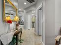 Bright hallway with tiled floors and neutral walls leads to kitchen, living room, and bedrooms at 1247 Travertine Ter, Sanford, FL 32771