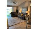 Inviting living room with comfortable seating, ceiling fan, and sliding glass door to the lake at 1247 Travertine Ter, Sanford, FL 32771