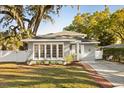Charming single-Gathering home boasting a well-manicured lawn and a welcoming brick path to the front door at 1303 E Central Blvd, Orlando, FL 32801
