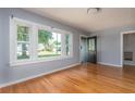 Bright living room with refinished hardwood floors, large windows, and freshly painted neutral walls at 1432 W Yale St, Orlando, FL 32804