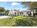 Well-kept single story home featuring an attached garage, lush green lawn and inviting walkway at 1505 Guinevere Dr, Casselberry, FL 32707